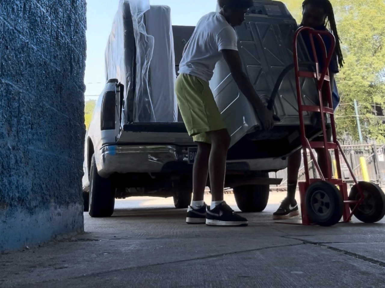 Movers loading a washer into a truck